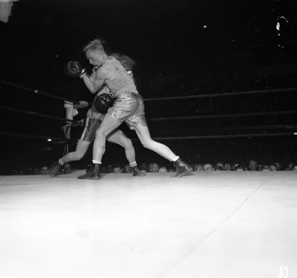 Herb Carlson of Idaho (front) competing against Don Brown of the California Aggies at the National Collegiate Athletic Association national tournament at the University of Wisconsin-Madison Field House.