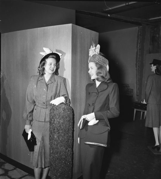 University of Wisconsin Women's Self Government Association style show, showing two women standing, dressed in suits, hats and gloves.