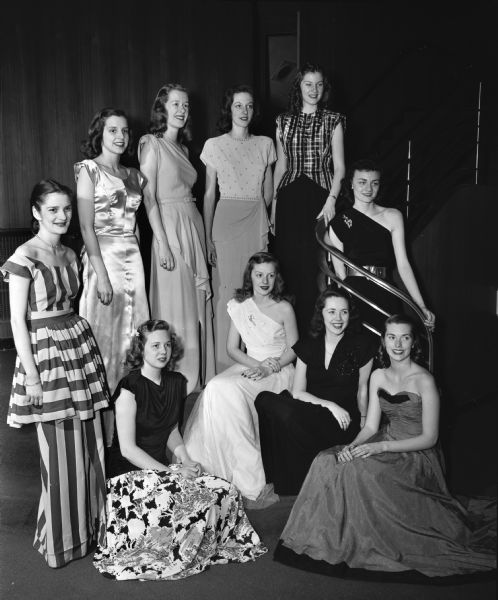University of Wisconsin Women's Self-Government Association style show "Confetti of Fashion" with ten models in formal dress. Standing, left to right: Betty Schrieber, Pittsburgh, Penn., Muriel Clapp, Madison, Aileen Courteen, Milwaukee, Jane Brickbauer, Plymouth, Rita King, Wisconsin Rapids, and Arline Paustion, Manitowoc. Seated left to right: Carol Johnson, Milwaukee, Beverly Sidie, Viroqua, Virginia Campbell, Milwaukee, and Joan Eakins, Evanston, Illinois.