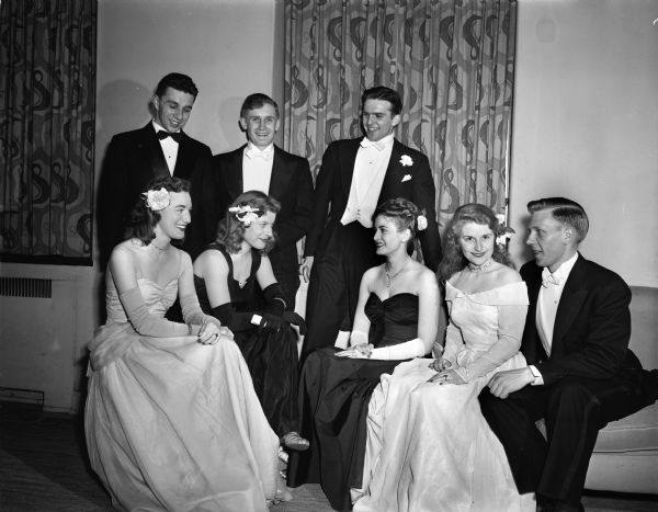 Group portrait of attendees at the 1947 Interfraternity Ball at the University of Wisconsin. Pictured standing left to right: Earl Numrick, Milwaukee; Howard Nethercut, Milwaukee; King Dick Tarrice, Duluth, Minnesota. Seating left to right: Rosemary Heronemus, Madison; Barbara Ann Larson, La Grange, Illinois; Mrs. Pat Terrice, Duluth, Minnesota; Phyllis Frudden, Wauwatosa, and Edward Rein, Madison.