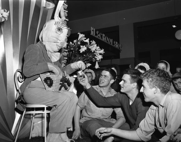 Students Coleman Jackson, Joe Dean, and Dick Sexton are shown meeting with the Easter Bunny that has been entertaining children in a leading department store.