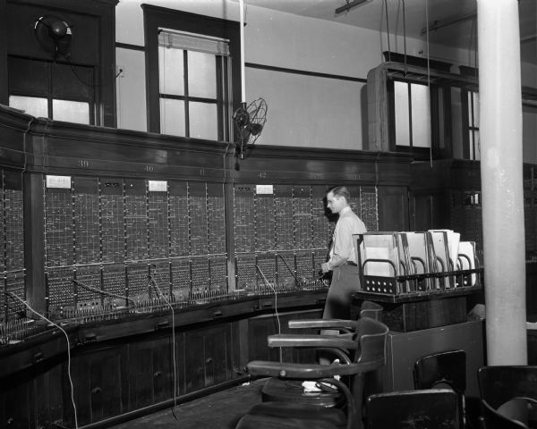 National telephone strike, showing one operator in the left half of east switchboard room of Wisconsin Telephone Company, 16 South Carroll Street.
