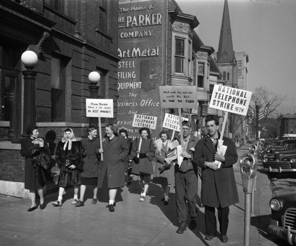 During the national telephone strike, strikers picket in front of the Wisconsin Telephone Company, 16 South Carroll Street.