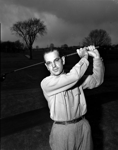 Alex Wilmott, golf pro at Maple Bluff Country Club since 1929, completing his golf swing.