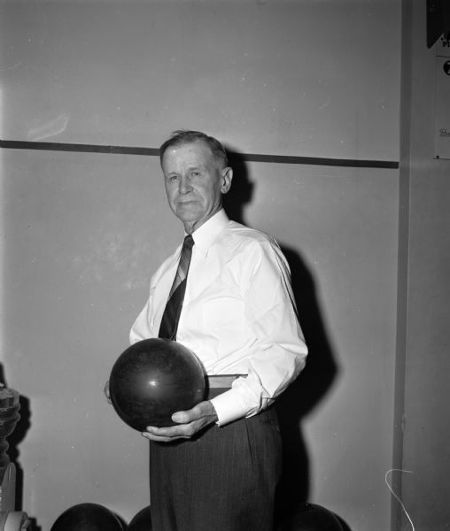 William Ott posed with a bowling ball.