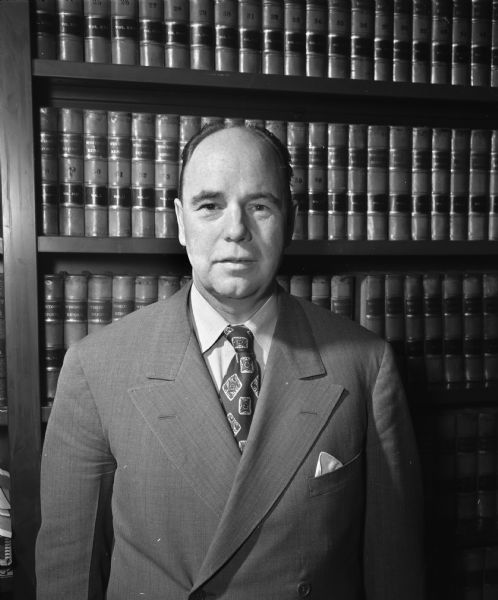 Portrait of Attorney Frank A. Ross, 3547 Topping Road, Shorewood Hills, in the library of the law firm of Spohn, Ross, Stevens & Lamb. A partner in the firm, Mr. Ross has also been active in the Madison War Chest, the Community Union and the Madison legal aid bureau.