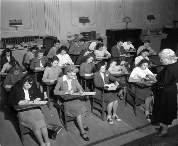Groves-Barnhart School for Secretaries, 502 State Street. Students are sitting in rows of desks and taking notes.