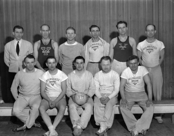 Men's state volleyball championship team from the Milwaukee YMCA. Members of the team are Stephen Burican, Robert Gromey, Boden Davis, Clarence Decker, Clarence Droegkamp, William Kuhnke, Clarence Nelson, Stanley Koniszka, Clarence Meyer, Harold Schroeder, John Szewyck, Harold Wolf and Will Pape.