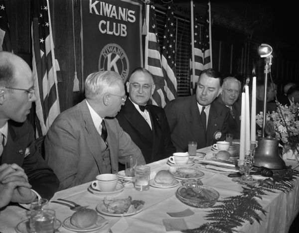Left to right, center, are Gov. Rennebohm, J.N. Emerson, the president of the Kiwanis International and guest speaker who told of joining the Communist party to learn its secrets, Howard Danford, president of the Madison Kiwanis, and Harrison Wood, Racine, member of the board of trustees of Kiwanis International.