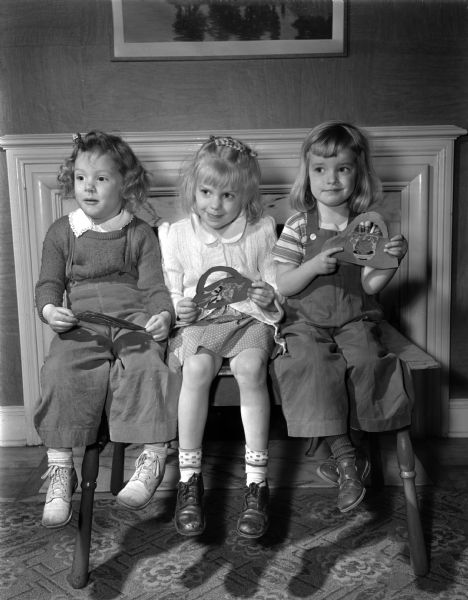 Three girls holding their lavender, green and pink May Baskets that they made in Marjorie Deakman's nursery school, 7 Bayside Drive, Lakewood. L to R: Barbara Sawyer, 375 Lakewood Boulevard.; Martha Wirig, 1712 Summit Avenue, and Martha Schmitz, Woodward's Grove.