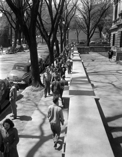 University of Wisconsin-Madison students along State Street east of Park Street. The State Historical Society building is on the right.