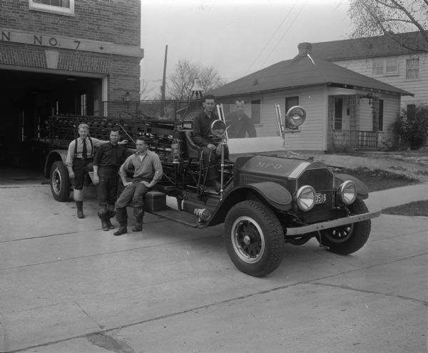 1919 ladder fire truck at Fire Station No. 7, 2410 Monroe Street. Fire fighters (L to R), Capt. Arthur Emerson, Joseph Roberts, Harold Klein, Arthur Halverson, and Daryl Griffin.