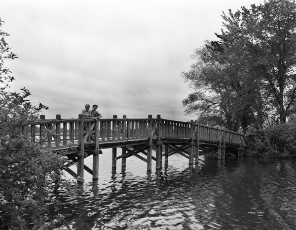 Jane and Jone Johnson, daughters of Mr. and Mrs. Lester Johnson of Black River Falls, on the bridge over the lagoon at Vilas Park.