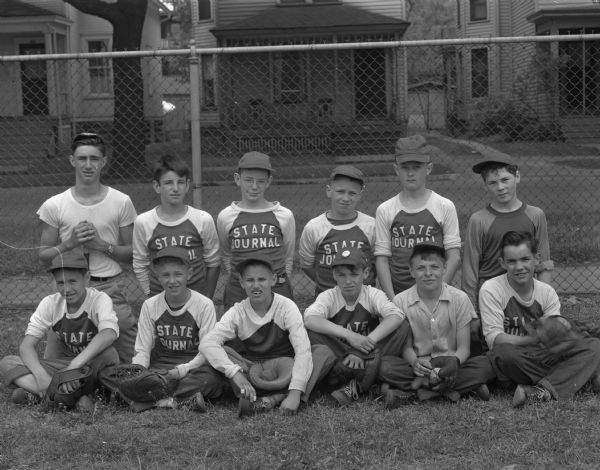 Group portrait of <i>Wisconsin State Journal</i> Midget League Baseball Team in uniform.  Front row, left to right: Gary Melcher, Tom Miller, Lee Remus, Charles Stull, Kay Randall and Dick Connery. Back row, left to right: Sam Ramos, manager of the team, Christ Ramos, Pete Barrett, Dick Simonson, Dick Olson and Ray Ryan.