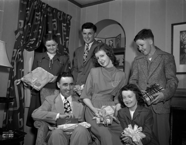 William C. Lathers, Jr., 216 Virginia Terrace, and his five children opening gifts on Fathers' Day. Children are, left to right: Marilyn, Jack, Ellyn Ann, Sally, and Mickey.