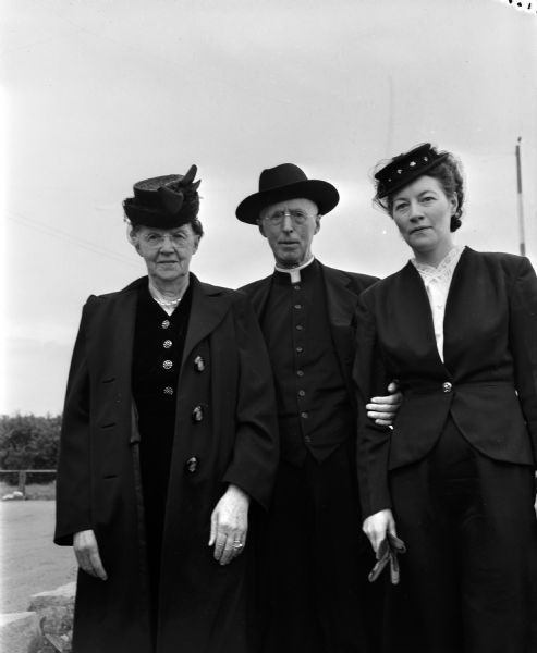 Rt. Rev. Msgr. E.C. O'Reilly, retired pastor of St. Joseph's Catholic Church, Baraboo, is shown boarding a airliner at Madison Municipal Airport with his sister Mrs. Mary Duffy, Genoa, and his niece Mrs. William Booth, Baraboo.  O'Reilly is flying to Ireland on a trip financed by his parishioners.