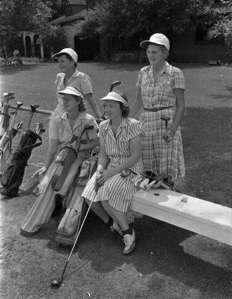 Four women waiting to tee off at Nakoma Derby Day golfing event. From left to right: Mrs. James B. Warner, Janesville; Mrs. W.L. Ivey, Cambridge; Mrs. Charles J. Mathais, Monroe; and Mrs. A.F. (Emily) Ahearn, Nakoma.