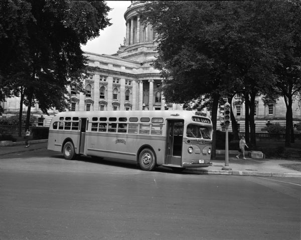 Pictured in front of the Wisconsin State Capitol is the Madison Bus Company's new 35 foot bus which seats 45 people. The bus will go into service the following Monday on the Fair Oaks-Nakoma line. The bus was purchased at the cost of $16,850.
