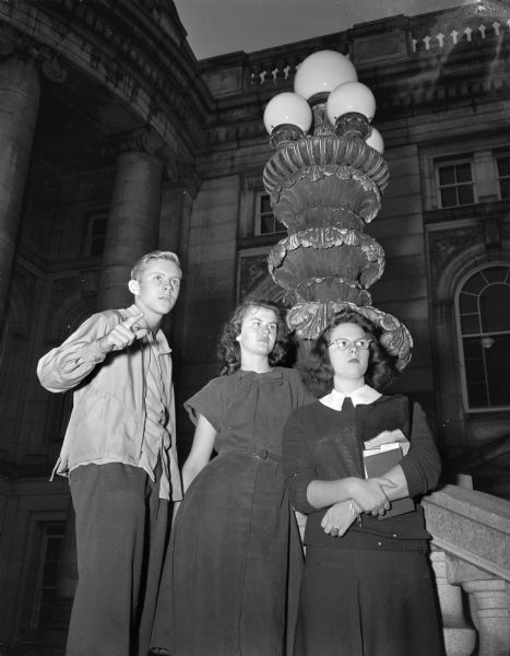 Three Madison high school students viewing Lake Monona from the steps of the Wisconsin State Capitol.  Pictured from left to right are: Ken Sticha, Anne Holden, and Jane Cox. Jane Cox, a new student at East High School, formerly resided in Indianapolis, Indiana.