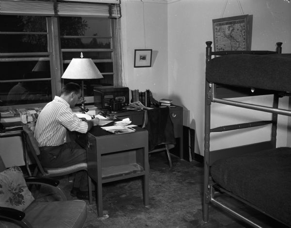 University of Wisconsin student seated at a desk in Slichter Hall, 625 Babcock Drive, named for Dr. Charles Sumner Slichter, Dean of the Graduate School, at the University of Wisconsin-Madison campus.