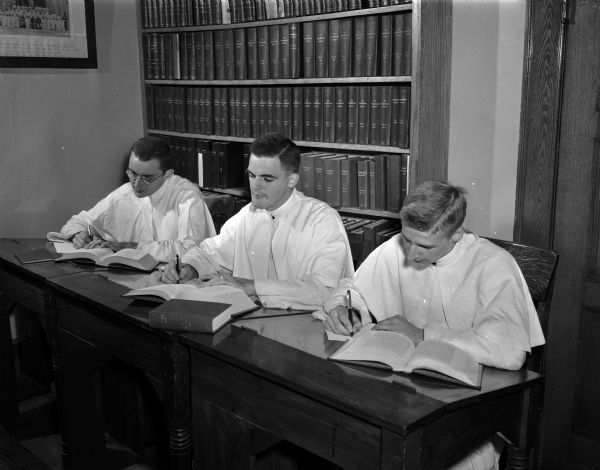 Three novices studying at Norbertine Novitiate, 4123 Monona Drive.  Left to right are James Mahoney, Joseph McCloskey, and James Gerrits. The Novitiate was formerly the home of Frank Allis.