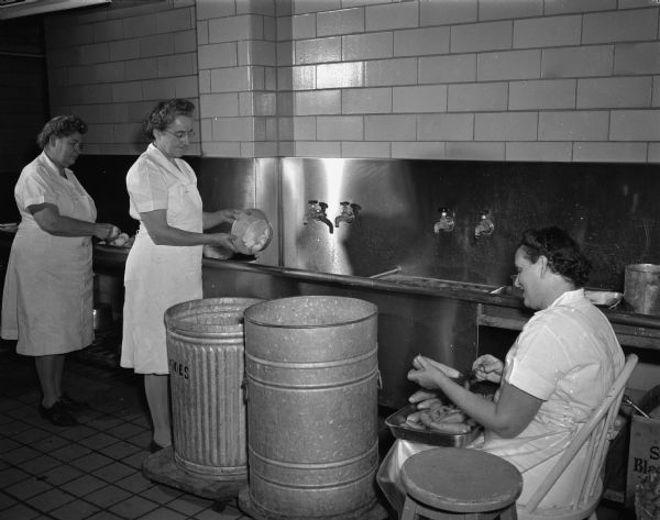 Three unidentified women in the kitchen at the Memorial Union, University of Wisconsin-Madison.