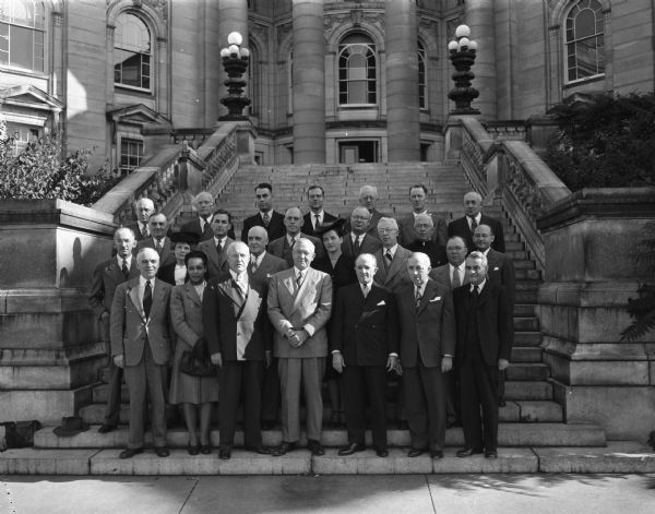 Members of Governor Oscar Rennebohm's Commission on Human Rights are shown outside of the Wisconsin State State Capitol for their first formal meeting.