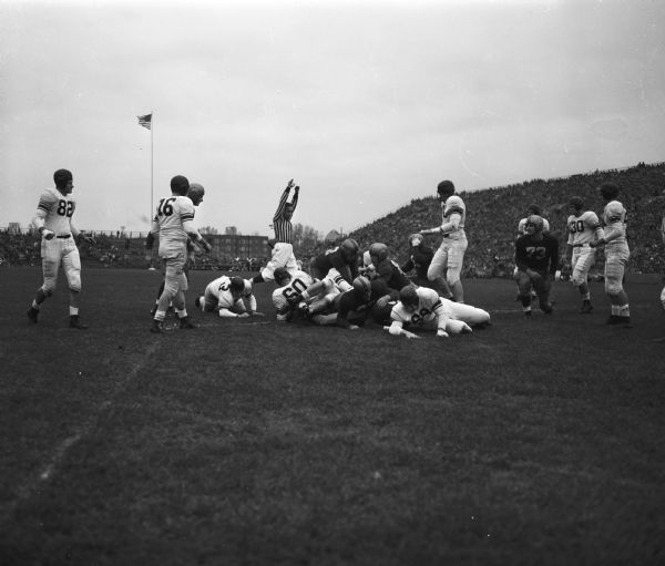 UW football player Clarence Self, #18, scoring a touchdown in University of Wisconsin vs. Northwestern game.