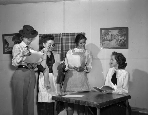Members of the University of Wisconsin Dames Club giving a play reading of "I Remember Mama".  Left to right are Mrs. Milton Schroeder, Mrs. Albert Booth, Mrs. Fred Stroebel, and Mrs. Arnold Milke in costume.