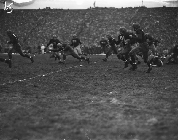 Halfback Clarence "Trigger" Self (18) flashed Wisconsin's Saturday first serious scoring bid when he returned a Michigan kickoff 70 yards from his own 17-yard line.