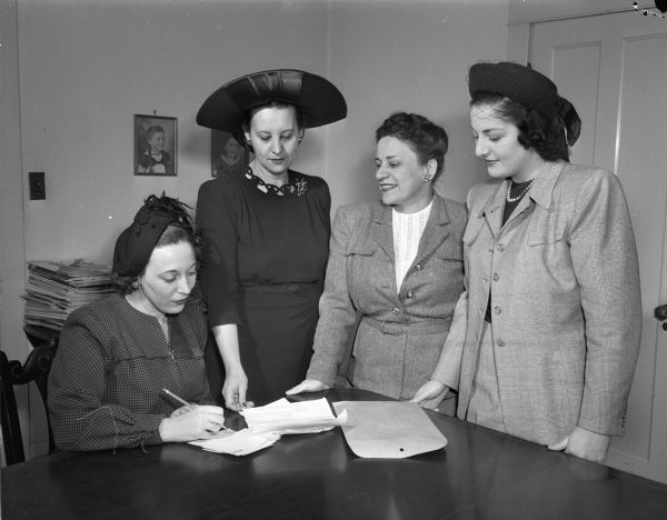 Four members of Hadassah Women's Zionist Organization, conferring about the arrangements for the Midwest regional conference. From left are: Mrs. E.J.(Rose G.) Juranek, Madison; Mrs. Shoolem Ettinger, president of the Hadassah region, Indianpolis; Mrs. David (Nena) Shapiro, Madison; and Mrs. H.K. Parks, Madison.
