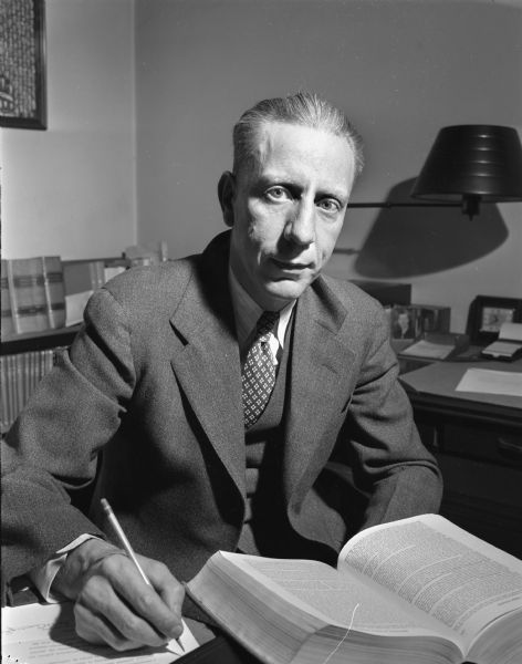 Portrait of Attorney Frederic E. Risser seated at his desk.