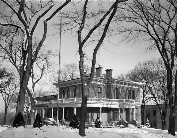 Wisconsin Governor's residence with snow on the ground, 130 East Gilman Street. The house was built for General Julius White in 1856. Succeeding owners were General George Delaplaine who added the first central heating system to the house, and later, J.G. Thorp, a Wisconsin lumberman. The first governor to live there was Jeremiah M. Rusk, 1883. The last governor to live in the residence was Oscar Rennebohm in 1950.