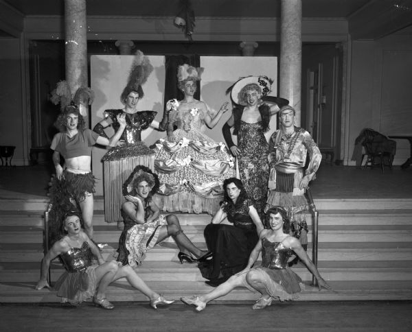 Participants in the "Fifty Years of Haresfoot" costume floor show are; (standing from left to right) Evan Clingman, John Griesbach, Don Minstor, Milt Beckman and Richard Godfrey. Seated on the steps: (from left to right) are Bill Zaegel, Jay Marker, Bill Schemmel and John Bergmann.