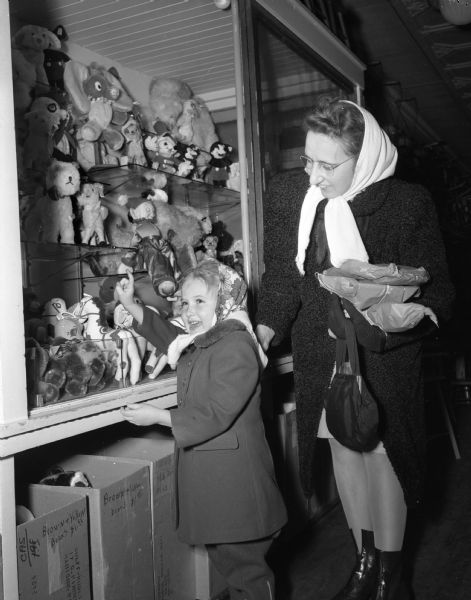 Jancie Cordes, DeForest, with unidentified woman looking at a display of stuffed animals (at Wolff, Kubly, and Hirsig).