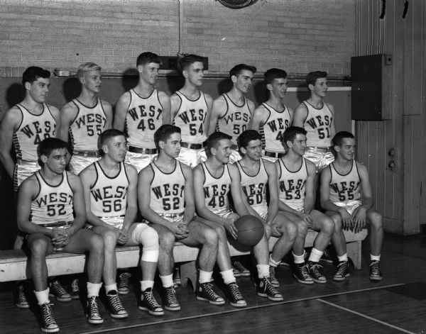 Group portrait of West High School Boys basketball team in uniforms.