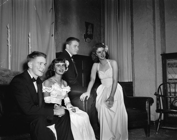 Two couples attending the  University Club's annual Christmas Assembly Ball. Pictured left to right: Frank Sarles, son of Prof. and Mrs. W.R. Sarles, 2237 Hollister Avenue; Marion Petry, daughter of Mr. and Mrs. Adolph Petry, 42 North Mills Street; Frank's brother William Sarles, and Joan Sexton, daughter of Mrs. and Mrs. Joseph C. Sexton, 58 Cambridge Road.