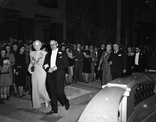 Governor Oscar Rennebohm and his wife Mary led the grand march, officially opening the Centennial Ball, held at the Wisconsin State Capitol. Following behind them are Attorney General John E. and Mary Martin.