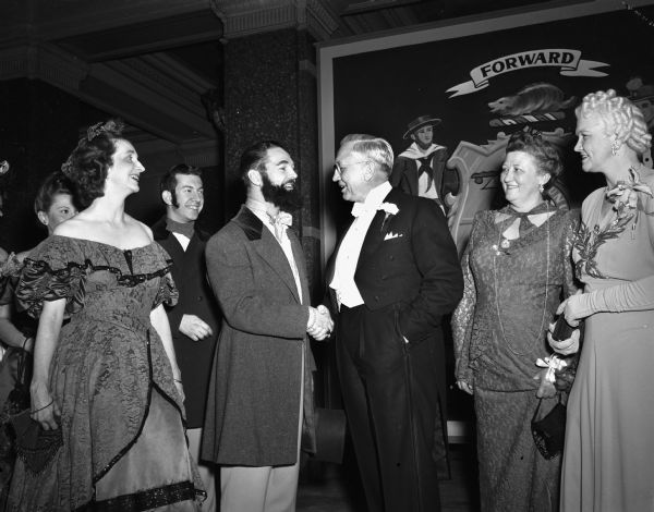 Paul F. Hunter, Jr. dressed as Wisconsin' first governor, Nelson Dewey, shaking hands with Governor Oscar Rennebohm. Left to right: Mrs. Richard C. Church, Donald Blood, Paul Hunter, Governor Rennebohm, Mrs. John E. (Mary) Martin, and Mrs Oscar (Mary) Rennebohm.
A tableau featuring Nelson Dewey and other state officials of 1848 was the highlight of the Wisconsin Centennial Ball.
