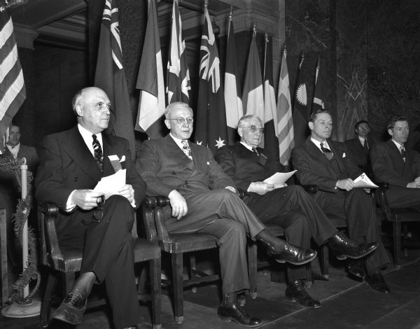 Seated in the Wisconsin State Capitol during a state centennial observance are, left to right: E.B. Fred, President of the University of Wisconsin; Governor Oscar Rennebohm; State Supreme Court Chief Justice Marvin B. Rosenberry; and Charles E. Bohlen, U.S. state department counselor.