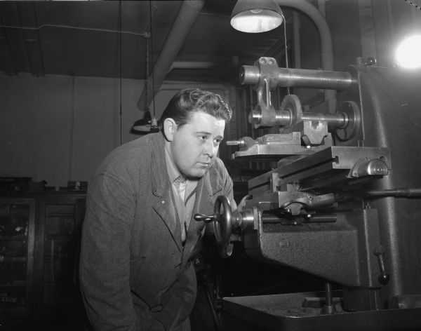 John Reuter, veteran and student, working at a milling machine at Madison Vocational and Adult Education School, 211-213 North Carroll Street.