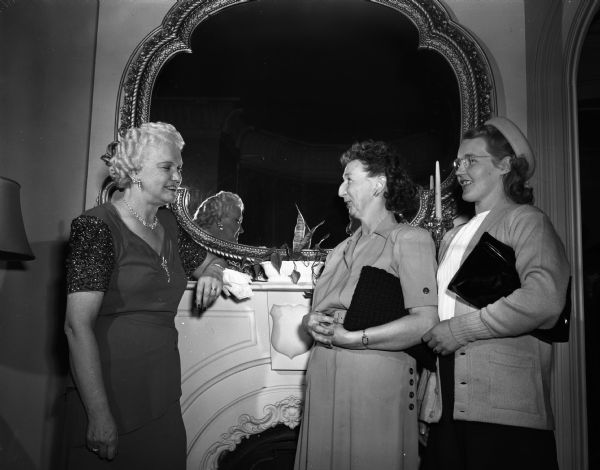 Wisconsin's First Lady, Mrs. Oscar (Mary) Rennebohm, left, greeting Mrs. Gaylord Flowers (left), Oconto Falls, and Mrs. Herbert Buseman, Gillett, at a tea at the executive residence as part of the University of Wisconsin Farm and Home Week activities.