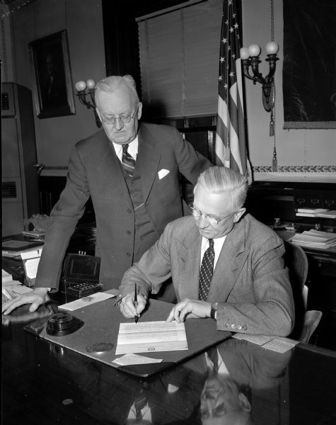 Governor Oscar Rennebohm and Justice John D. Wickham signed a proclamation asking all Wisconsin citizens to observe "American Brotherhood Week," sponsored by the National Conference of Christians and Jews.
