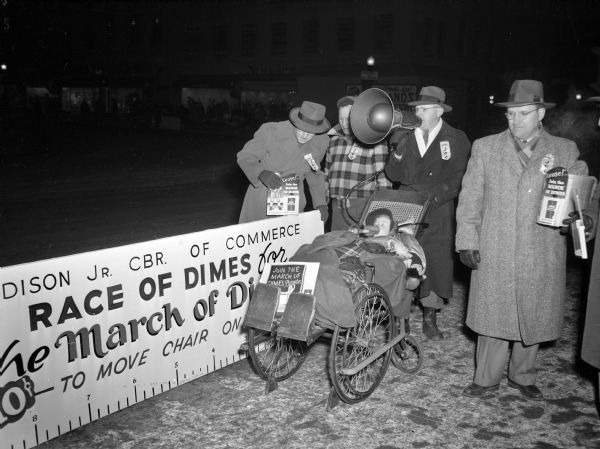 Members of the Junior Chamber of Commerce south team, who took part in the "Race for Dimes" to raise money for the March of Dimes. Standing left to right: Homs Schwahn; Ben Trumbo, team captain; Lloyd Kohl, and Stan Hungerford. Mr. Kohl is pushing a wheelchair occupied by Gene Bokina, a polio victim.
