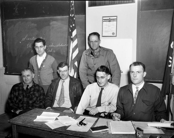 Town of Madison Volunteer Firemen Association holding their first meeting under its new constitution at the Hillcrest School, Mineral Point Road. Pictured seated left to right: Joe Stormer, fire chief, town of Madison; Ed Brendler, fire chief, Blooming Grove; Al Falter, president of the association, and Robert Gerhart, association secretary. Standing left to right: Harold Munroe, board of directors and J.G. Dickson, association vice president.