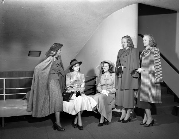 University of Wisconsin co-eds modeling spring fashions at the Women's Self Government Style Show at the University of Wisconsin Union Theater. Standing left to right: Betty Einhorn, San Antonio, TX; twins Joanne and Luanne Prehn, Wausau. Seated left to right: Shirley Rae Gage, Wauwatosa, and Pattie Neilson, Milwaukee.