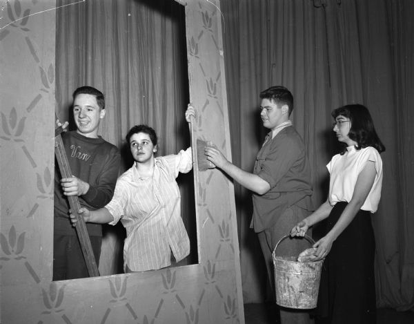 Four teenagers working backstage as apprentices for the Madison Theater Guild. Pictured from the left are: Eugene Van Hekle, Carol Cowan, Bob Hart, and Joan Chamberlin.