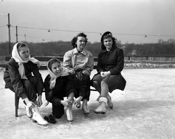 Junior members of the Madison Figure Skating Club at Vilas Park. Pictured left to right: Ann Zander, daughter of Mr. and Mrs. Arnold S. Zander; Judy Hicks, daughter of Mr. and Mrs. Stratton Hicks; Jane Piper, daughter of Mr. and Mrs. C.W. Piper, and Georgia Bernard, daughter of Paul Barnard.