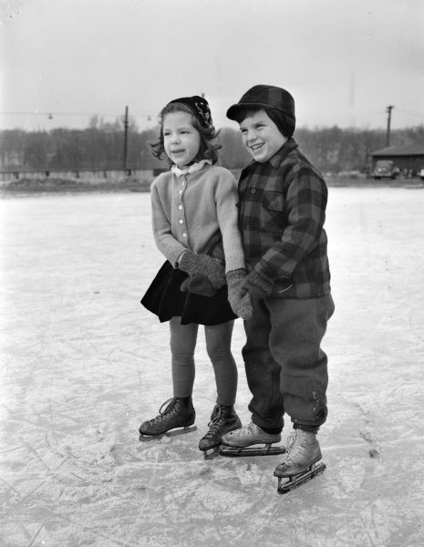 Two young charter members of the Madison Figure Skating Club at Vilas Park. Pictured left to right: Karen Nelson, daughter of Mr. and Mrs. Alan Nelson, and Fritz Balsley, son of Mr. and Mrs. H.A. Balsley.