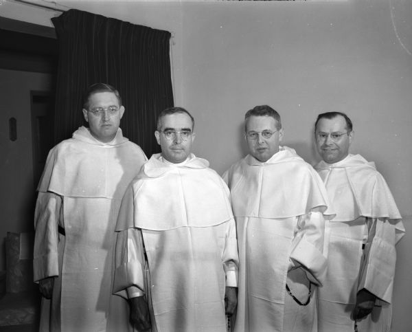 Four priests at Blessed Sacrament Catholic Church, 2131 Rowley Avenue.